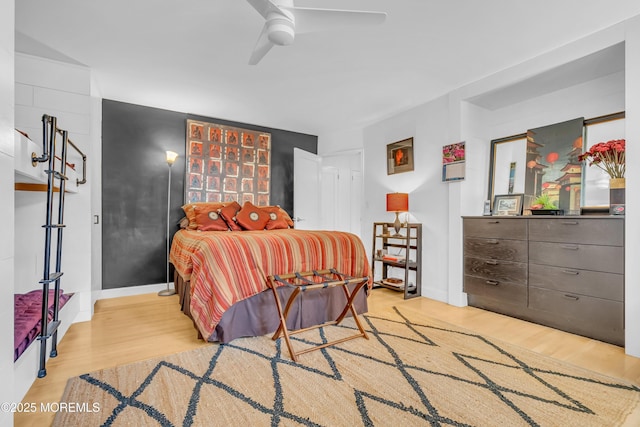 bedroom with ceiling fan and light wood-type flooring