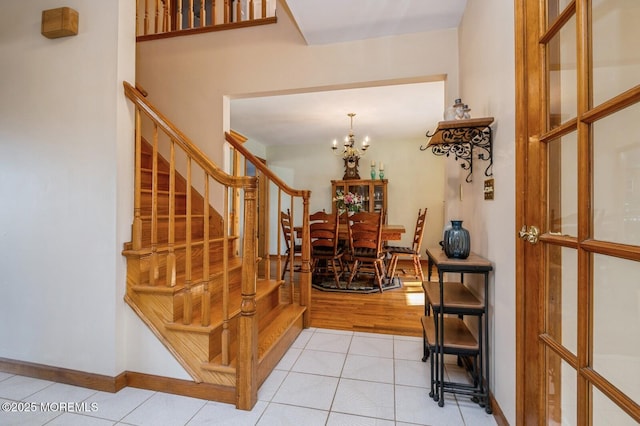 foyer entrance featuring light tile patterned floors and a chandelier