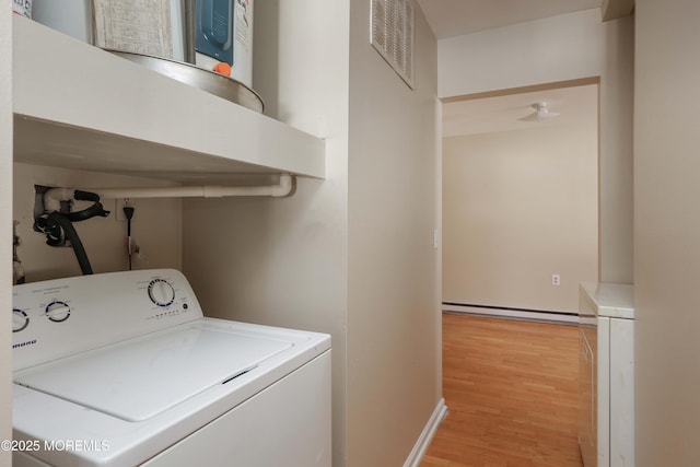 washroom with baseboard heating, washer / clothes dryer, and light hardwood / wood-style floors