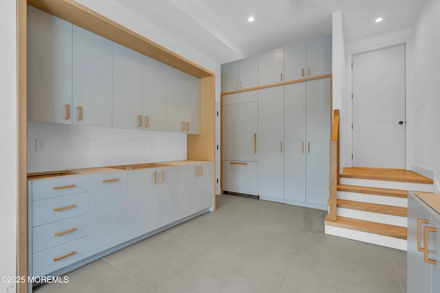 kitchen with white cabinetry and light tile patterned floors