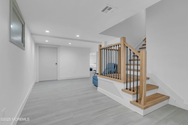 stairway with hardwood / wood-style flooring