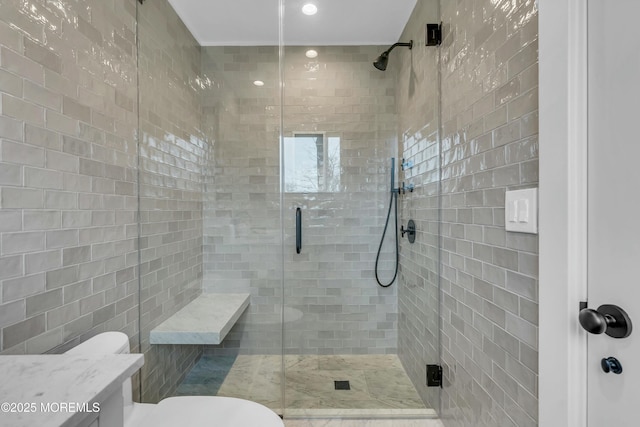 bathroom featuring vanity, toilet, and a shower with shower door