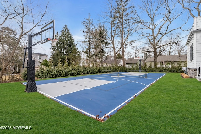 view of sport court with a lawn