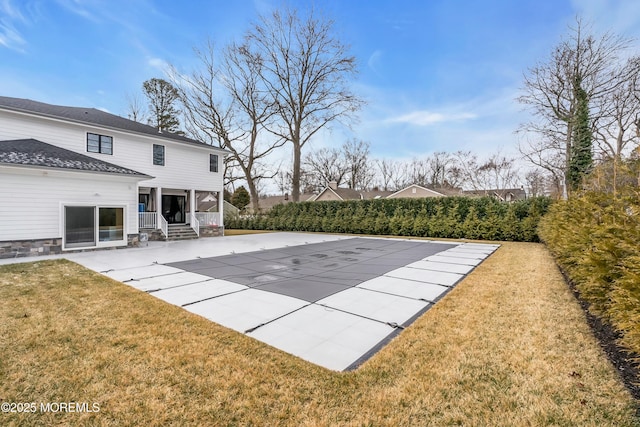 view of pool featuring a patio and a lawn