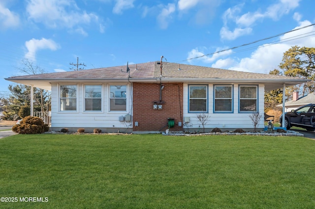 rear view of house with a yard