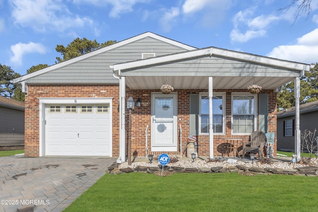 view of front of property with a garage, a front yard, and covered porch