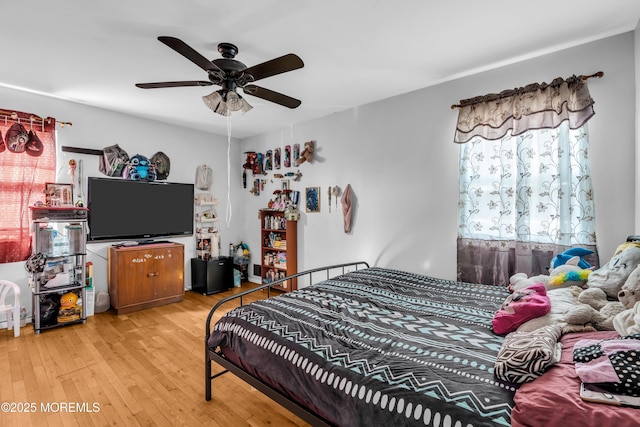 bedroom with hardwood / wood-style flooring and ceiling fan