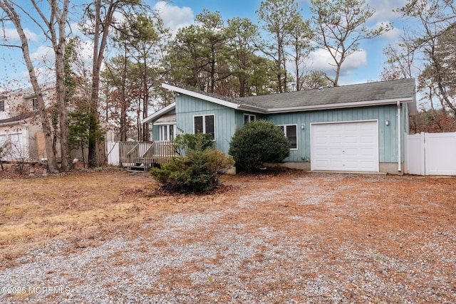 ranch-style home with a garage and a deck