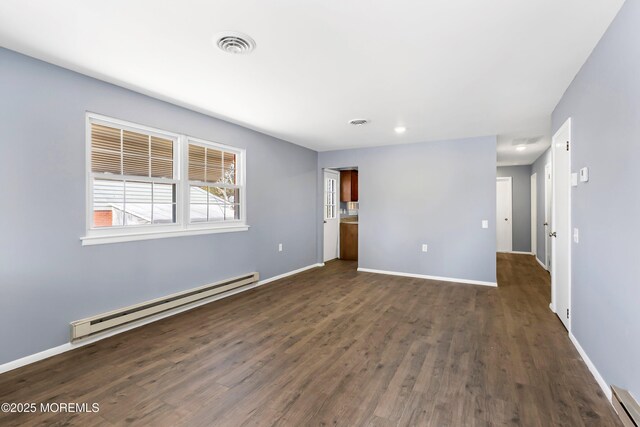 unfurnished room featuring a baseboard radiator, dark wood-style flooring, visible vents, baseboards, and baseboard heating