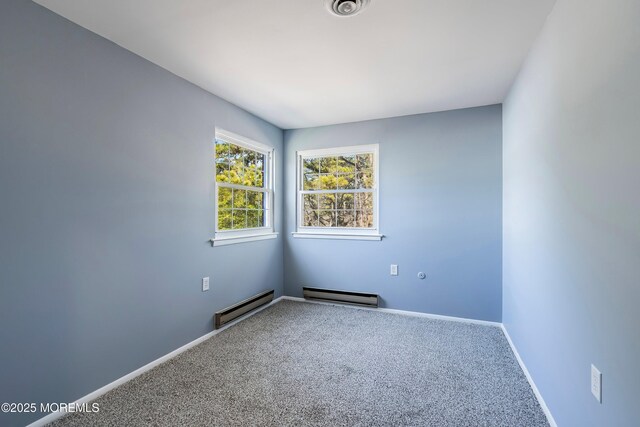 carpeted empty room featuring a baseboard radiator, visible vents, and baseboards