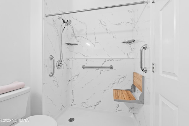 full bathroom with a marble finish shower and toilet