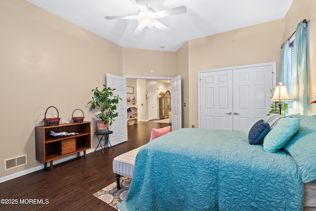 bedroom featuring a closet, visible vents, a ceiling fan, wood finished floors, and baseboards