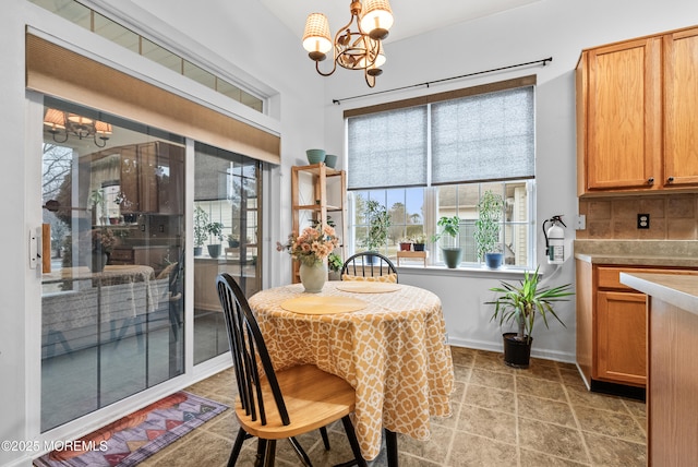 dining space with a chandelier and baseboards