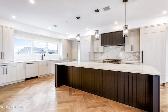 kitchen with a spacious island, decorative light fixtures, premium range hood, and stove