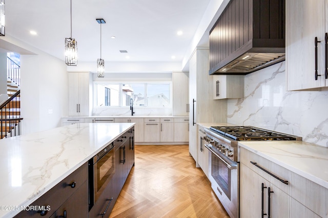 kitchen with stainless steel appliances, pendant lighting, custom exhaust hood, and light stone countertops