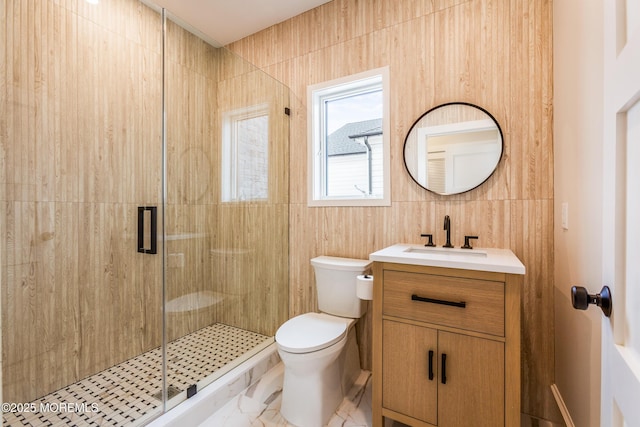 full bathroom with a shower stall, vanity, toilet, and marble finish floor