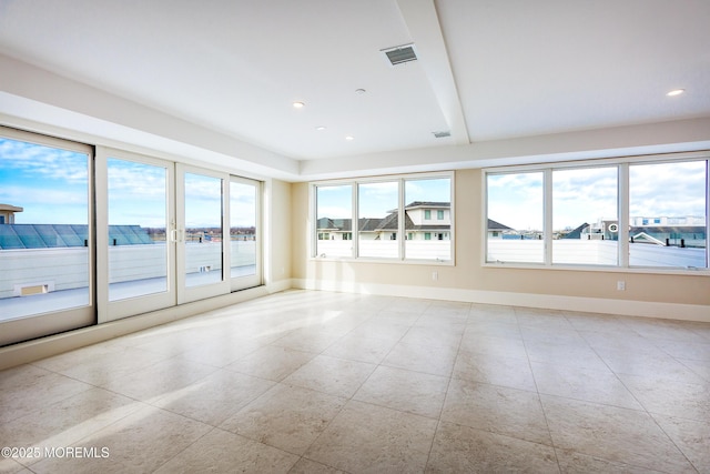 unfurnished room with plenty of natural light, visible vents, baseboards, and recessed lighting