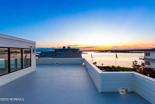 view of patio featuring a water view and a balcony