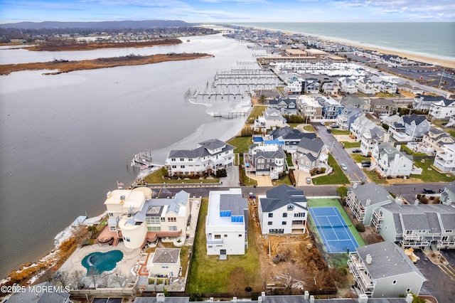 birds eye view of property featuring a residential view, a water view, and a beach view