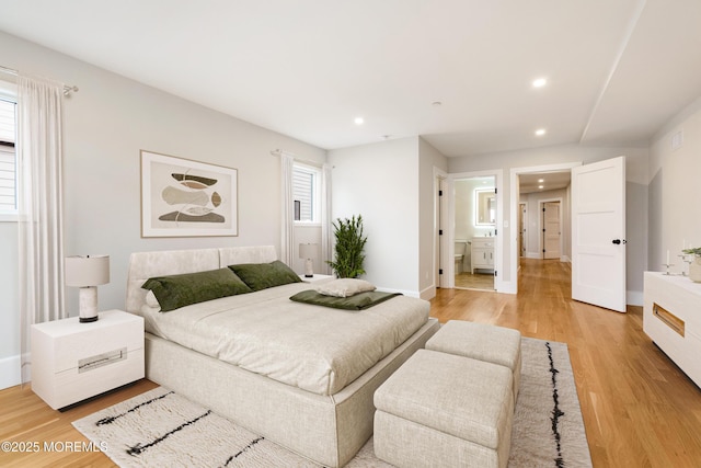 bedroom featuring light wood finished floors, baseboards, and recessed lighting