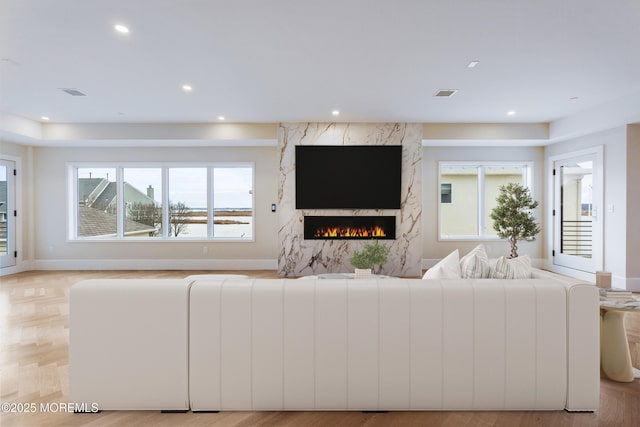 living area with recessed lighting, radiator, a fireplace, and baseboards