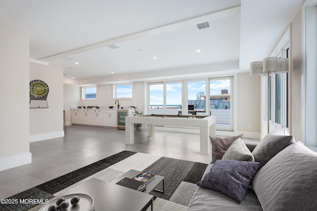 living room with baseboards, wine cooler, visible vents, and recessed lighting