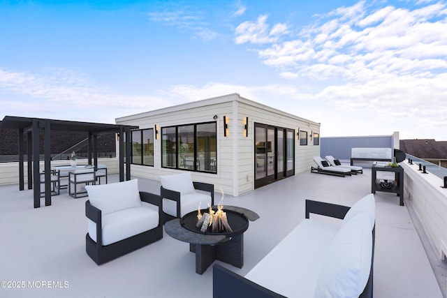 view of patio / terrace with an outdoor living space with a fire pit