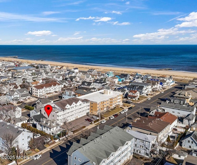 birds eye view of property with a beach view and a water view