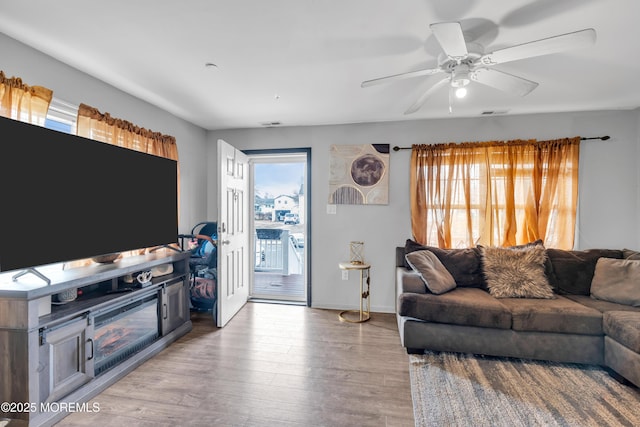 living room featuring ceiling fan and light wood-type flooring