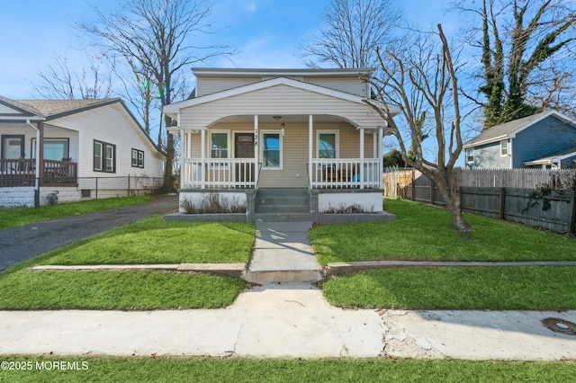 bungalow-style house with a porch and a front lawn