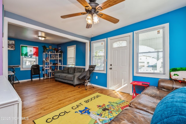 living room featuring hardwood / wood-style floors and ceiling fan