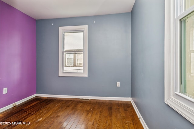 spare room featuring dark hardwood / wood-style floors