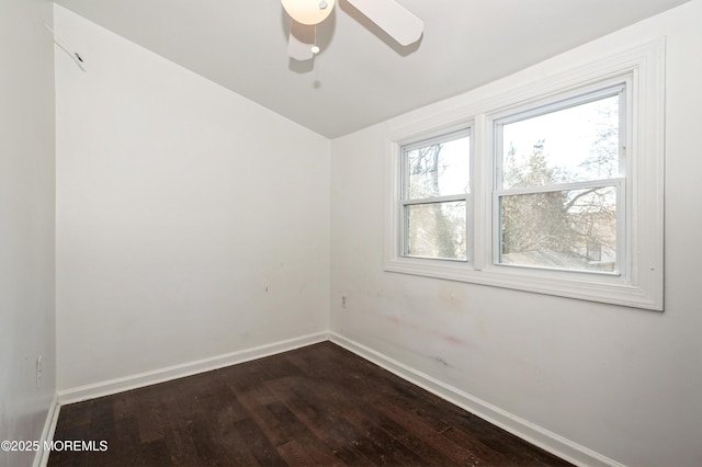 unfurnished room featuring lofted ceiling, hardwood / wood-style floors, and ceiling fan