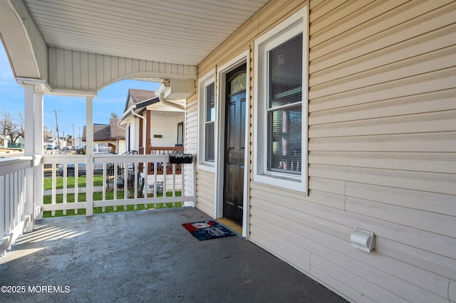 view of exterior entry with covered porch