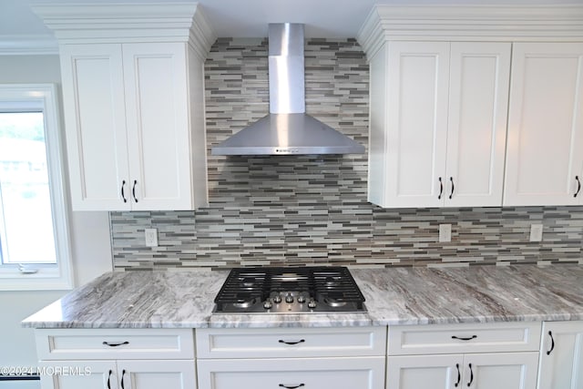 kitchen with white cabinetry, stainless steel gas cooktop, and wall chimney exhaust hood