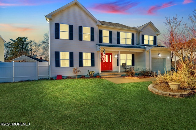 view of front of home with a yard, a garage, and a porch