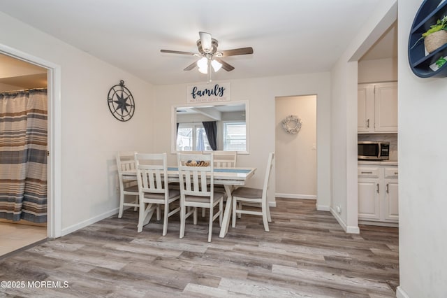 dining area featuring ceiling fan and light wood-type flooring