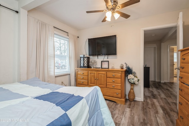 bedroom featuring ceiling fan and dark hardwood / wood-style flooring