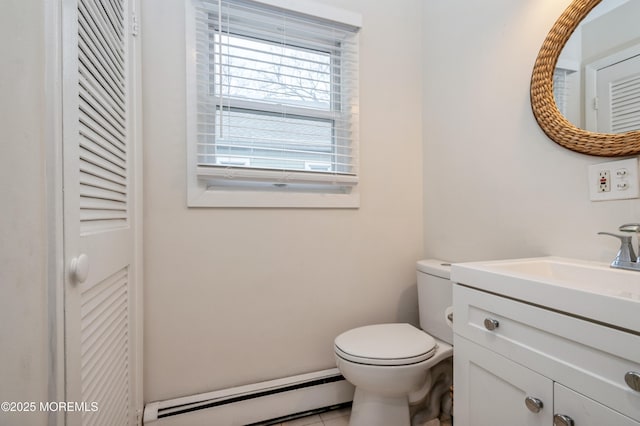 bathroom featuring a baseboard radiator, vanity, and toilet