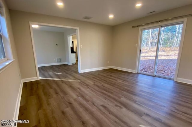 spare room with dark wood-type flooring