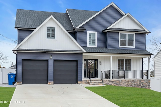 view of front of property featuring a garage, covered porch, and a front lawn