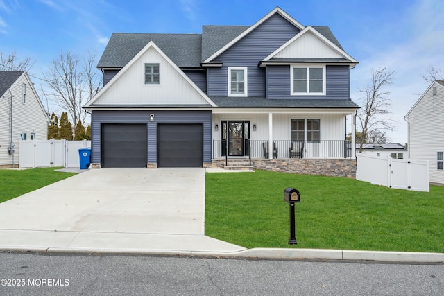 view of front of house featuring a garage, covered porch, and a front lawn