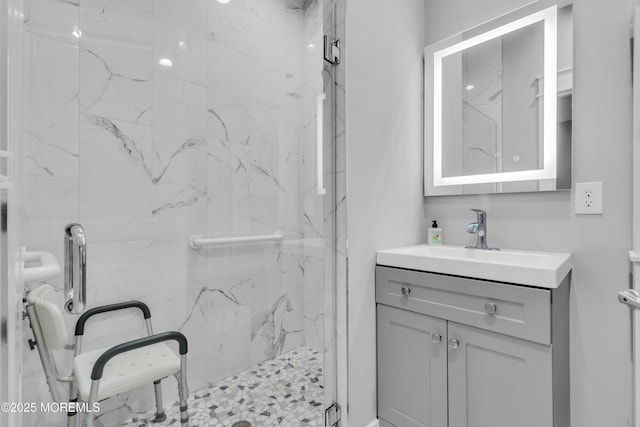 bathroom with vanity and a shower with shower door