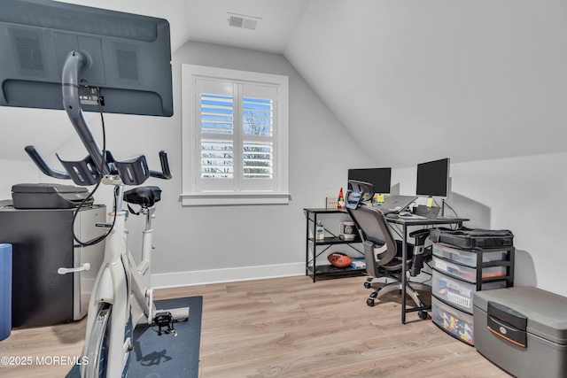 home office featuring vaulted ceiling and light wood-type flooring