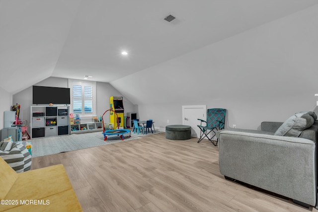 game room with lofted ceiling and light hardwood / wood-style flooring