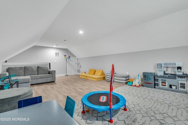 playroom with vaulted ceiling and hardwood / wood-style floors