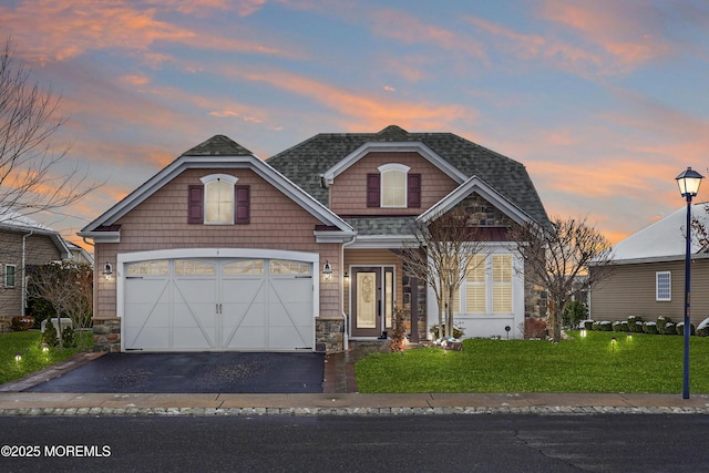 craftsman house featuring a garage and a lawn