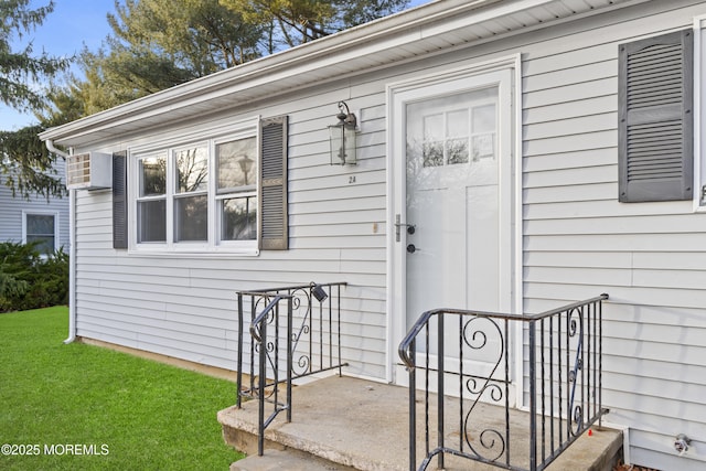 property entrance with a lawn