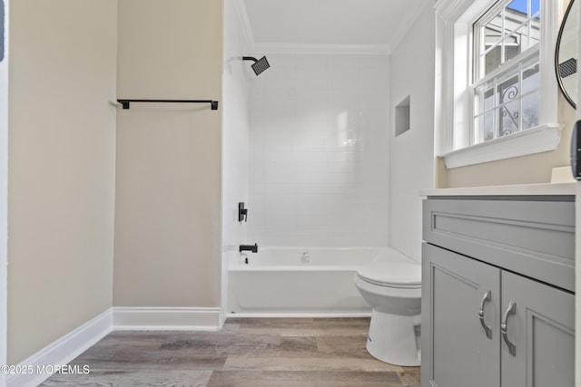 full bathroom with vanity, wood-type flooring, ornamental molding, and tiled shower / bath