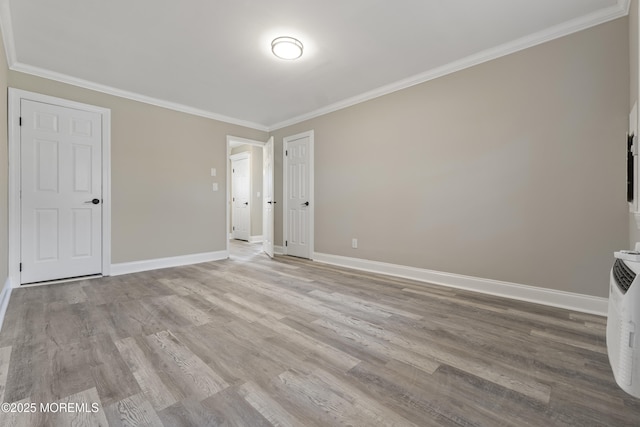 interior space with crown molding and light hardwood / wood-style flooring